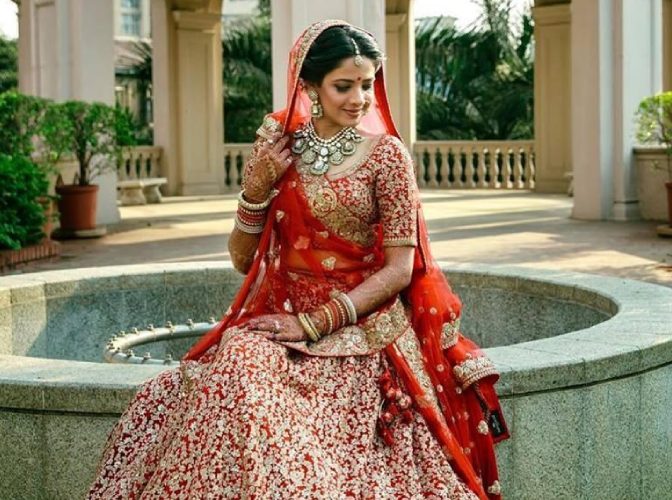 Premium Photo | A bride poses for a photo in her traditional bridal gown.